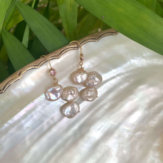 Elegant earrings composed of Natural Keshi pink and white pearls hanging from gold filled hooks with pink cubic zirconia bezel