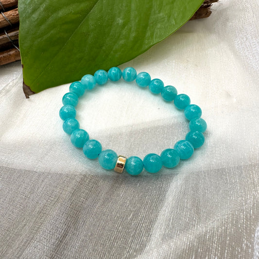 Blue Amazonite Bracelet on white cloth – bead and gold accent detail shot