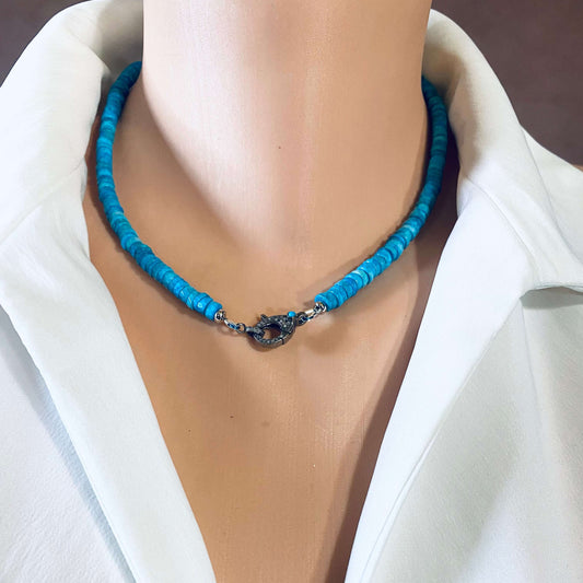 Turquoise howlite beaded necklace with oxidized silver pavé clasp displayed on a mannequin.