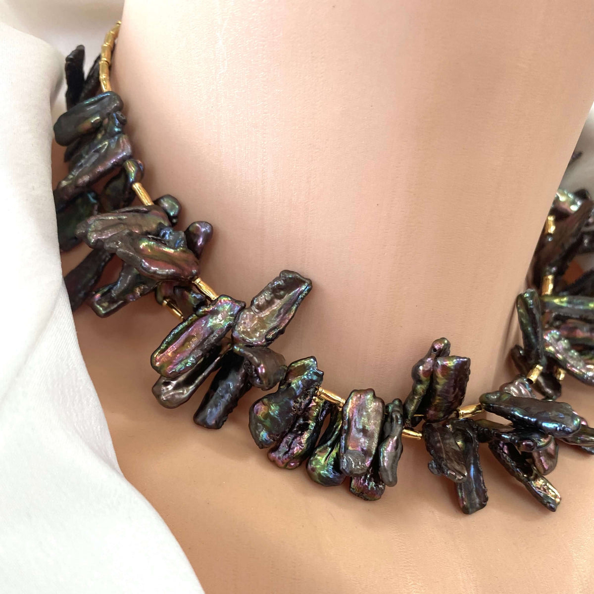 Black pearl choker necklace neckline close-up, peacock Biwa stick pearls statement choker