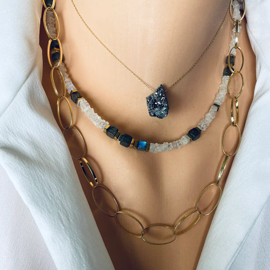 Elegant jewelry display featuring the June birthstone moonstone in a layered necklace design.