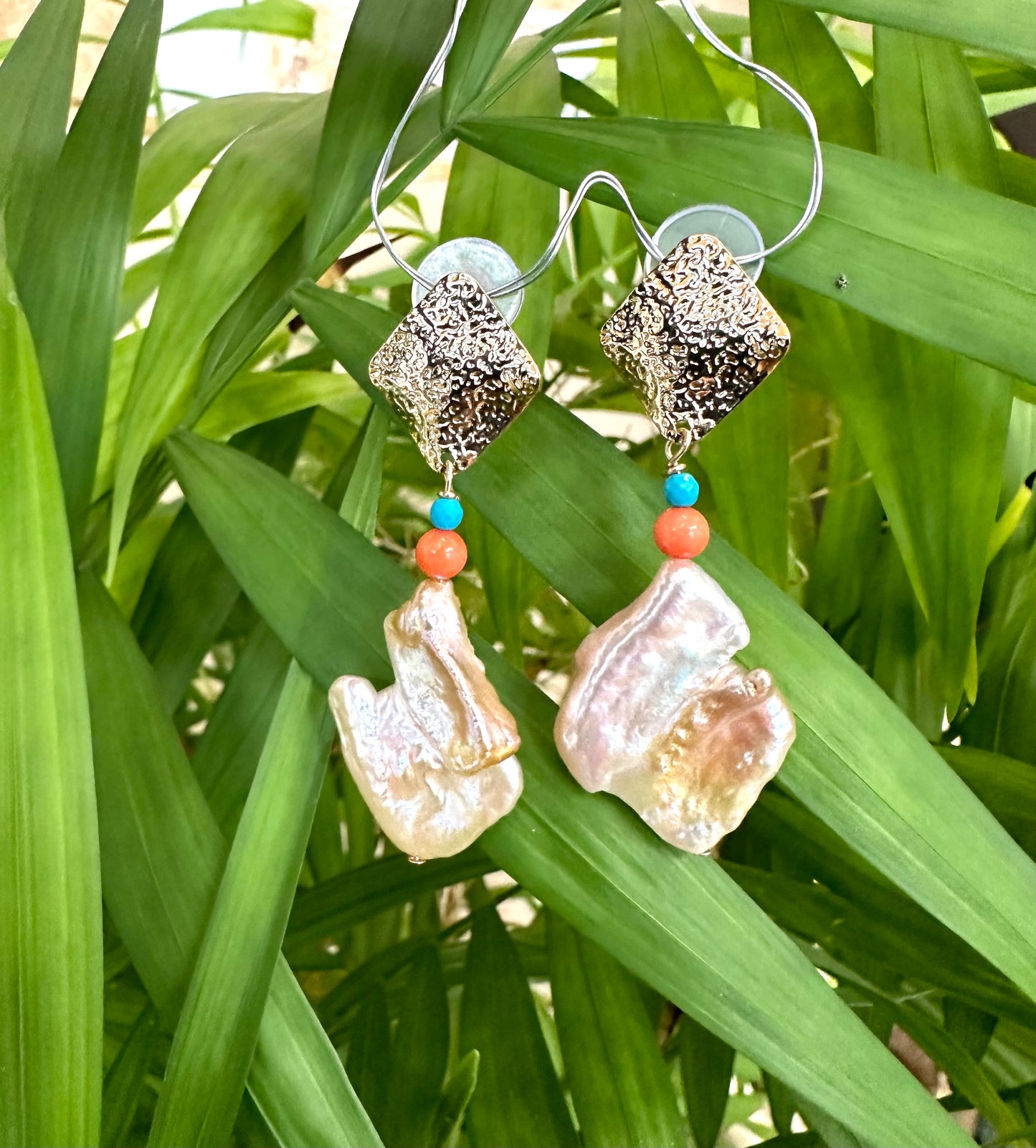 Baroque Pearl Turquoise Coral Earrings – Chunky Gold Statement featuring baroque pearls, turquoise, and coral on vibrant greenery.
