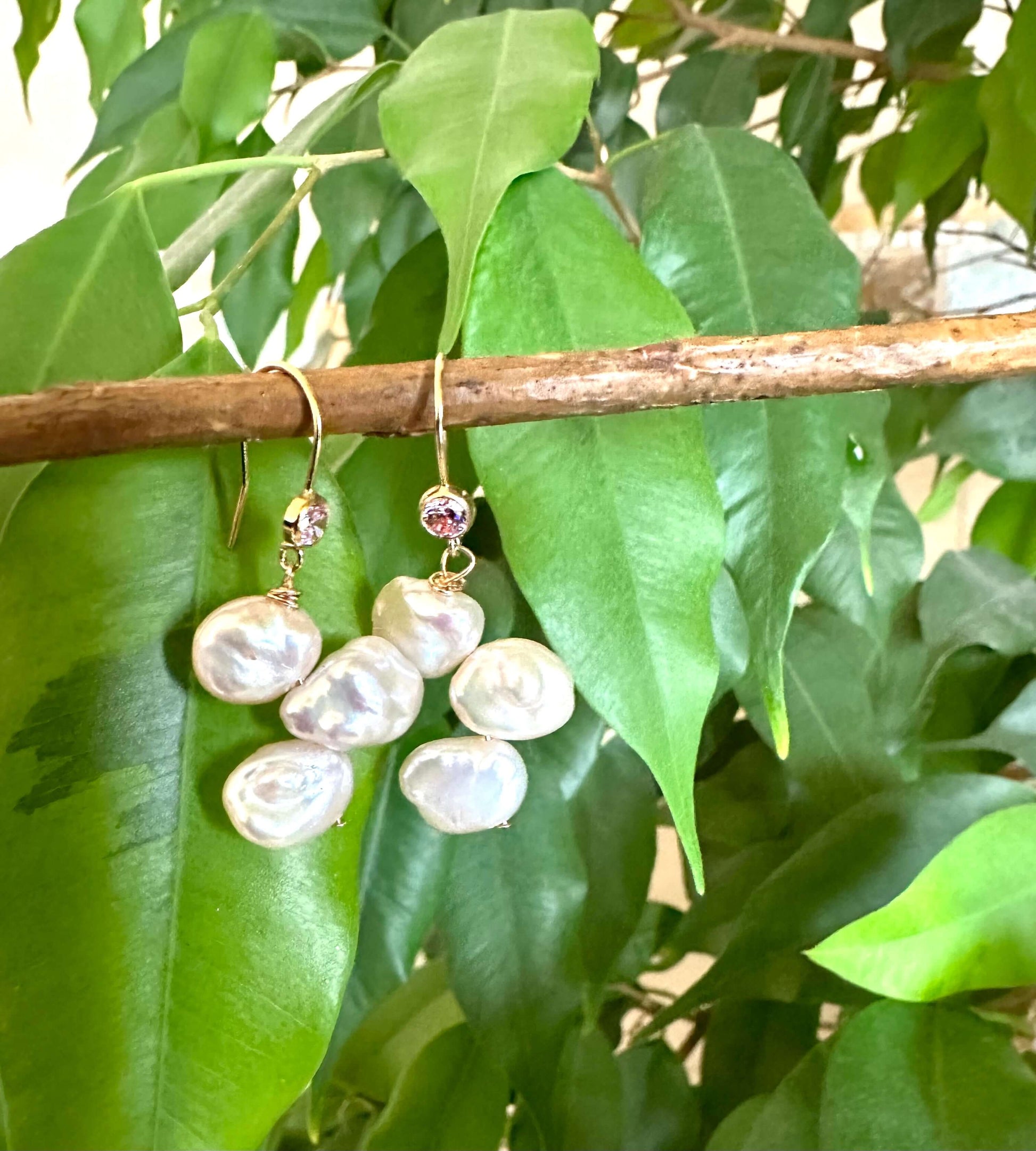 Elegant earrings composed of Natural Keshi pink and white pearls hanging from gold filled hooks with pink cubic zirconia bezel
