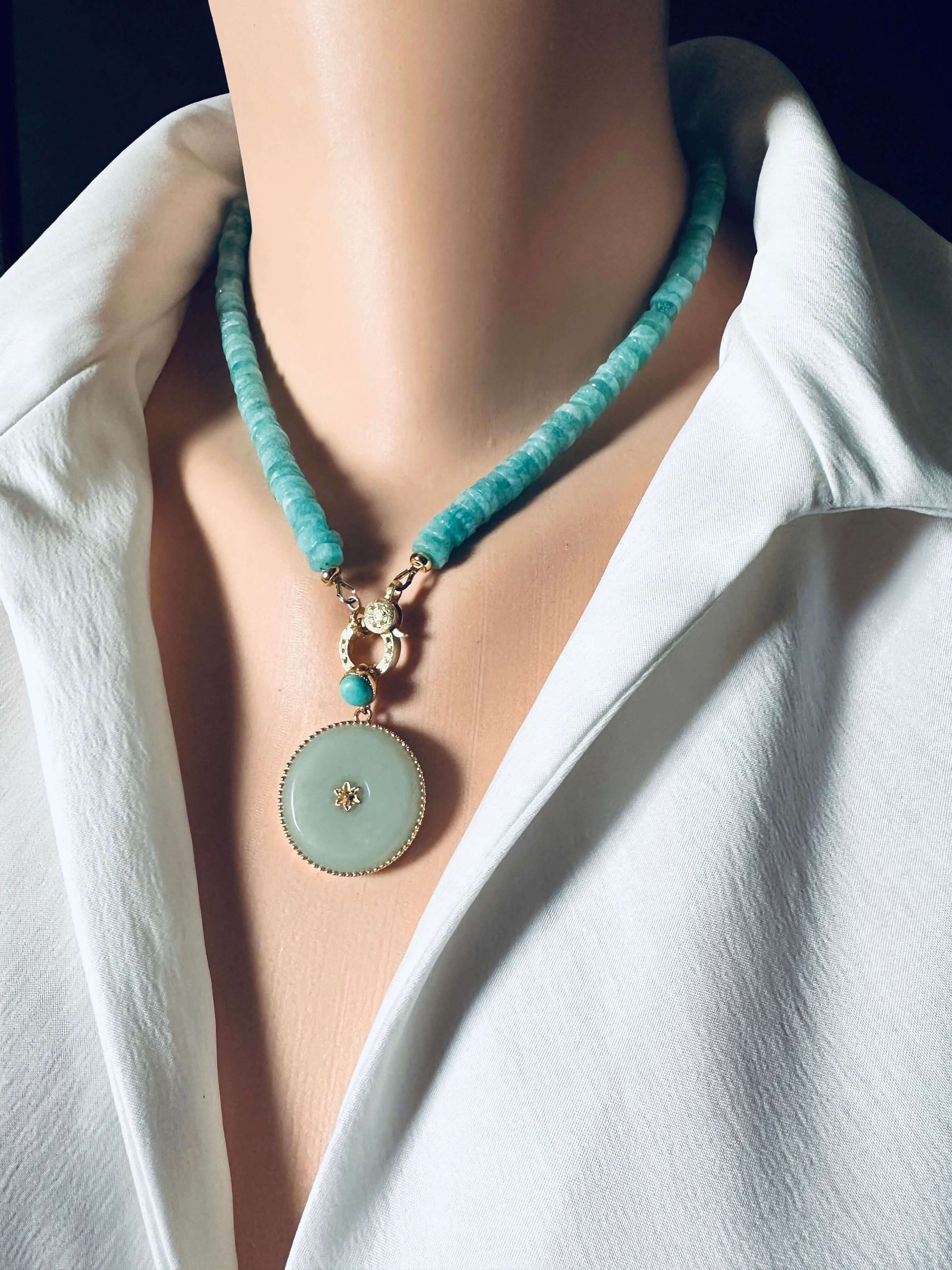Blue amazonite gemstone necklace with a round pendant, showcasing faceted beads and elegant gold accents.