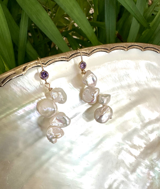 Keshi Pearl Drop Earrings – 14k Gold Filled with Purple CZ showcased on a shell background.