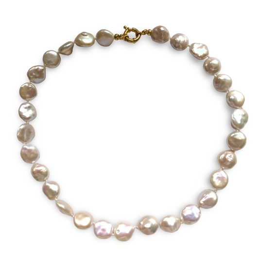 A white coin pearl necklace with irregular, lustrous beads in soft pink champagne and taupe tones, connected by a gold clasp, shown on a plain white background.