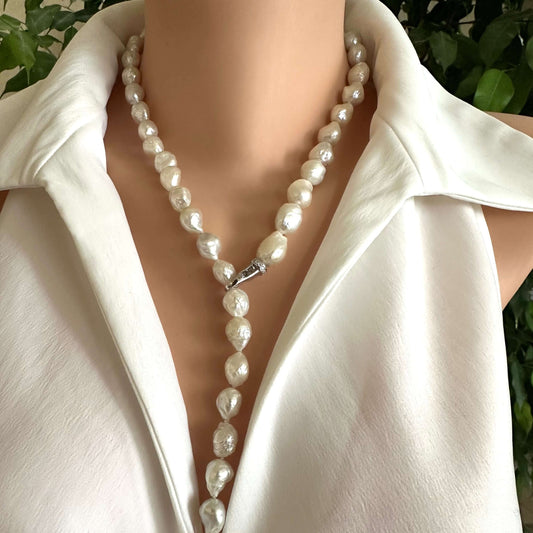 Edison baroque pearl Y necklace displayed on a model, highlighting the organic baroque shape and rhodium clasp.