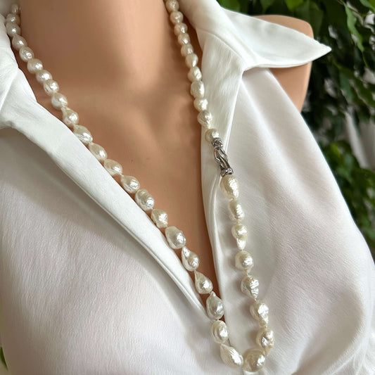 Edison baroque pearl Y necklace showcased on a mannequin, featuring hand knotted pearls and a rhodium clasp, stylishly draped.