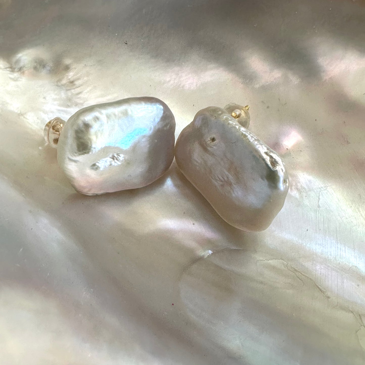 Baroque pearl stud earrings with white rectangular freshwater pearls on white shell, showing natural luster and handcrafted finish.