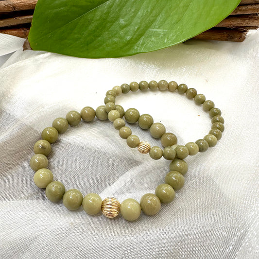Green Olivine Jasper Bracelet pair displayed on cloth – two-bracelet close-up