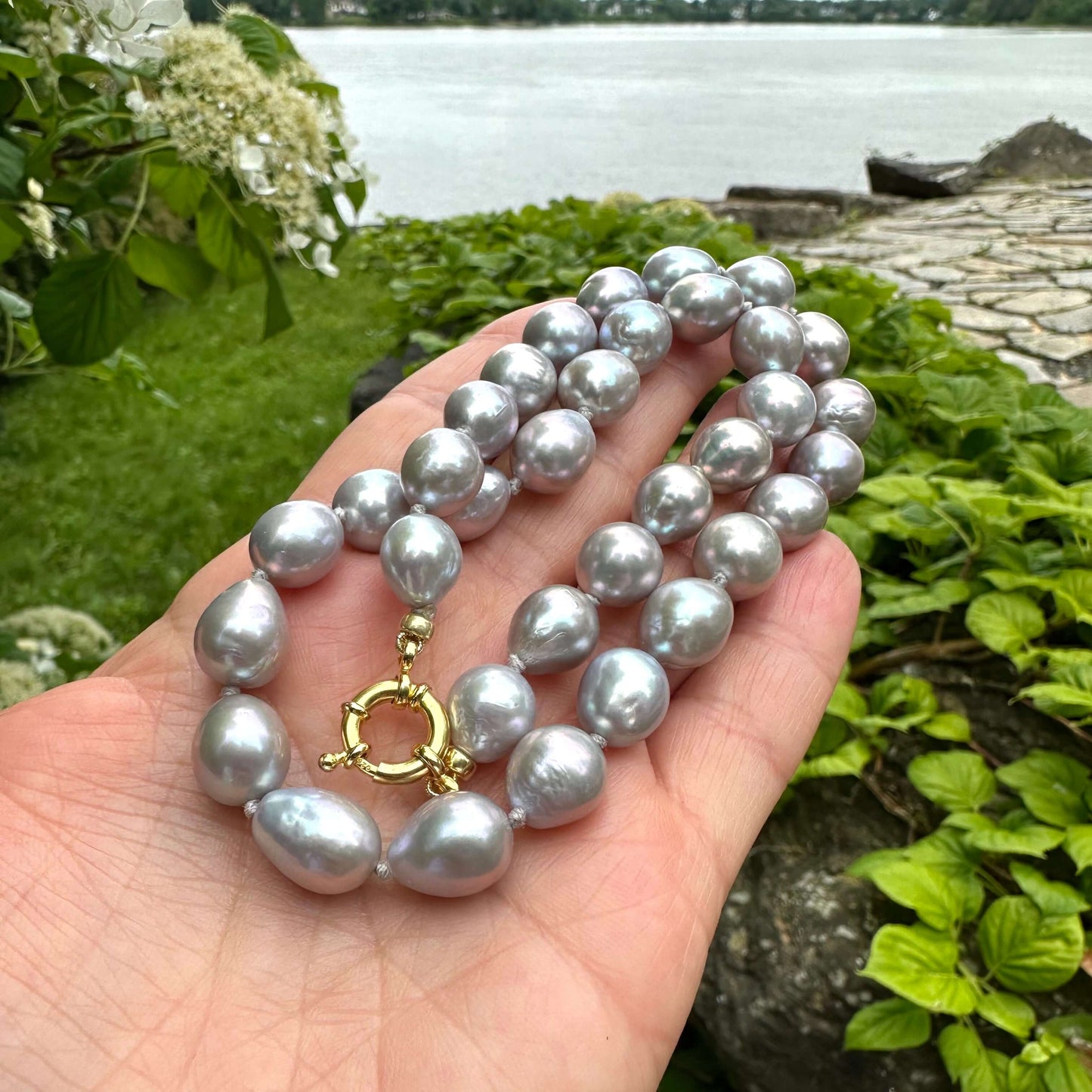 Close-up of Edison Grey Pearl Necklace beads and gold accents – natural light