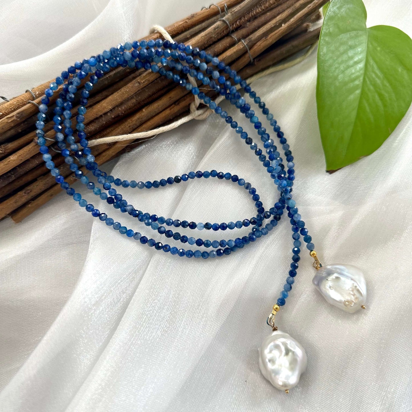 Kyanite and baroque pearl lariat necklace featuring denim-blue kyanite beads and large white baroque pearls.