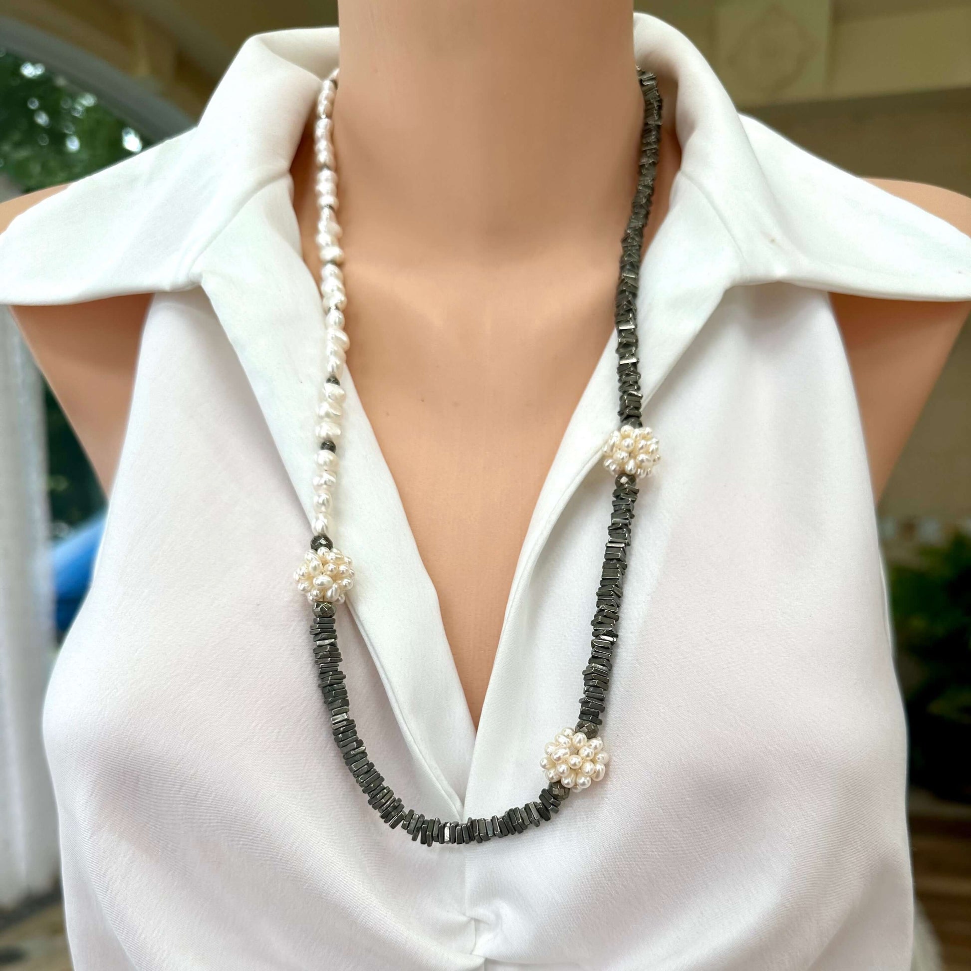 Frontal close up of pyrite and pearl necklace on mannequin