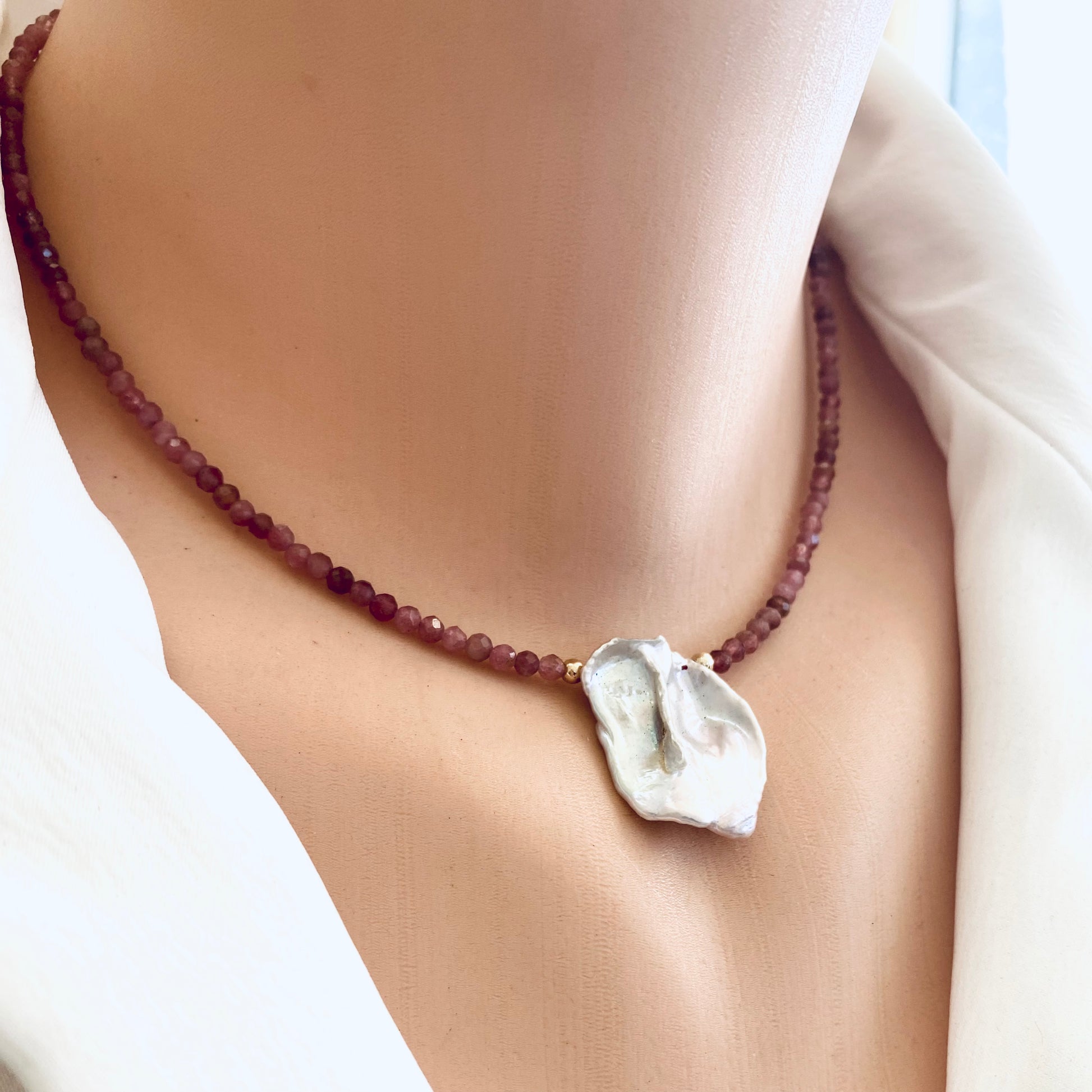 Pink tourmaline keshi pearl choker necklace styled close to the neckline for elegant look