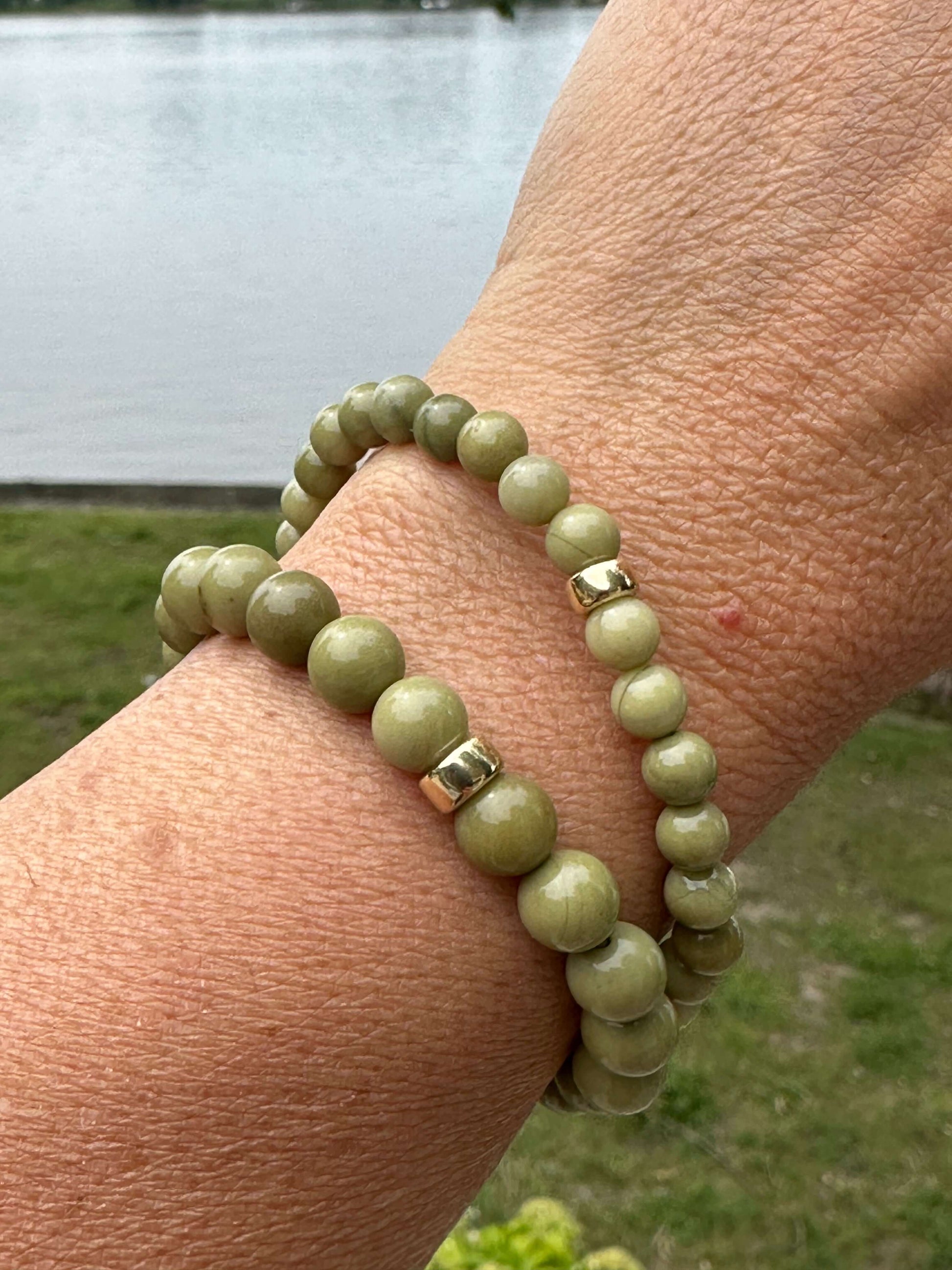 Olive green jasper bracelet – 6mm or 8mm, 14K gold filled worn on wrist by the water.