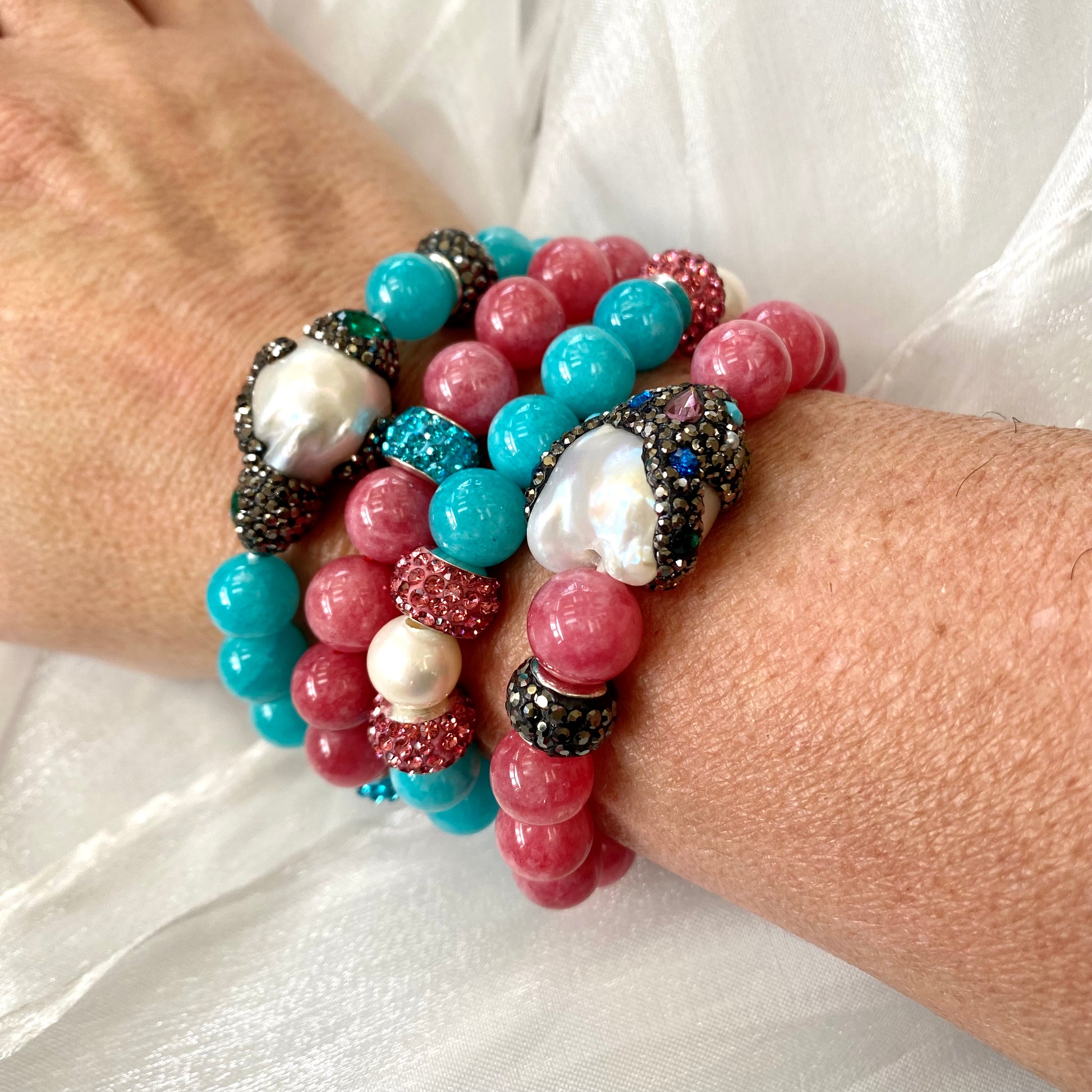 Jade pearl bracelets stacked on wrist