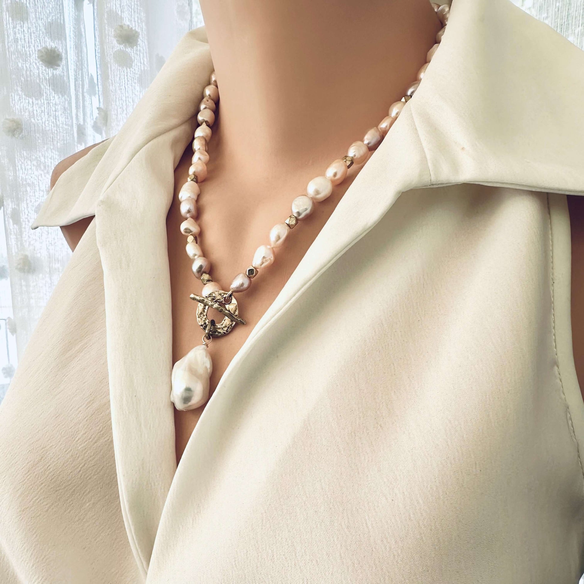 Close-up of pastel pearl necklace on mannequin showing iridescent pastel pearls