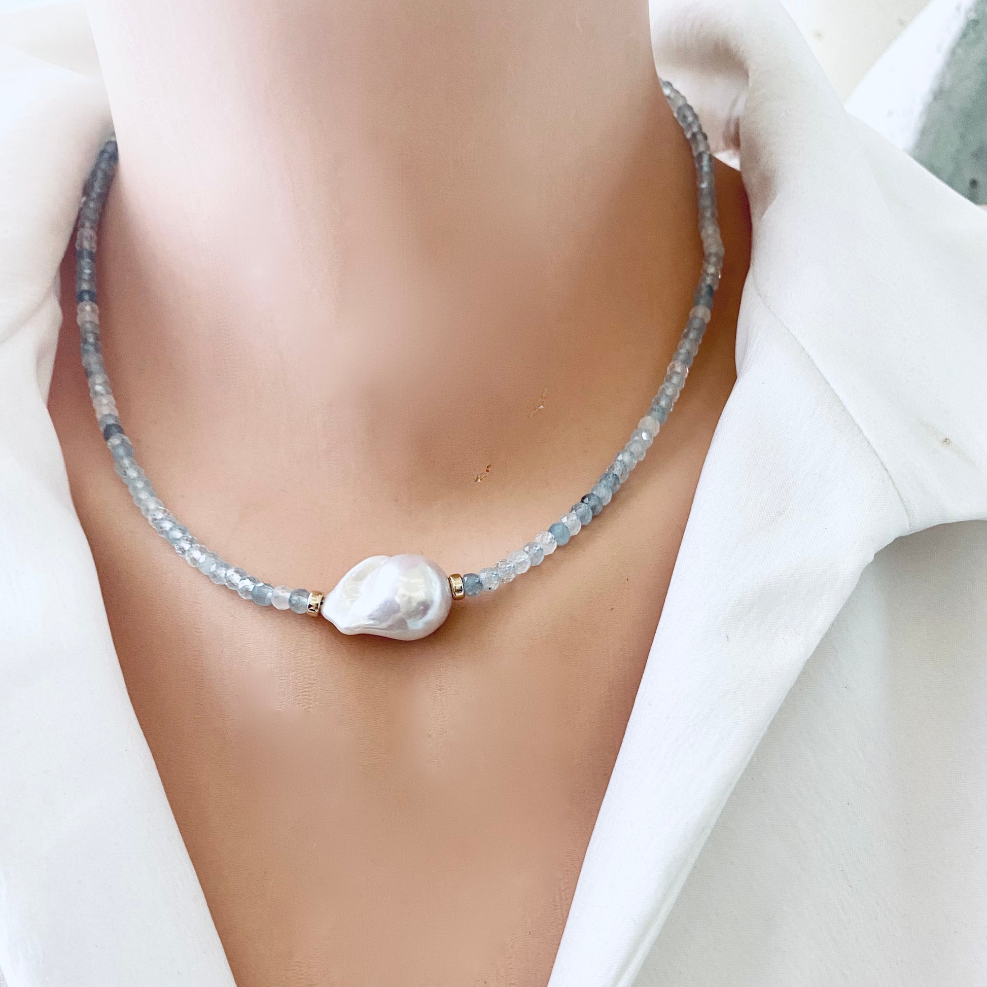 Aquamarine pearl necklace worn on mannequin, close-up side angle
