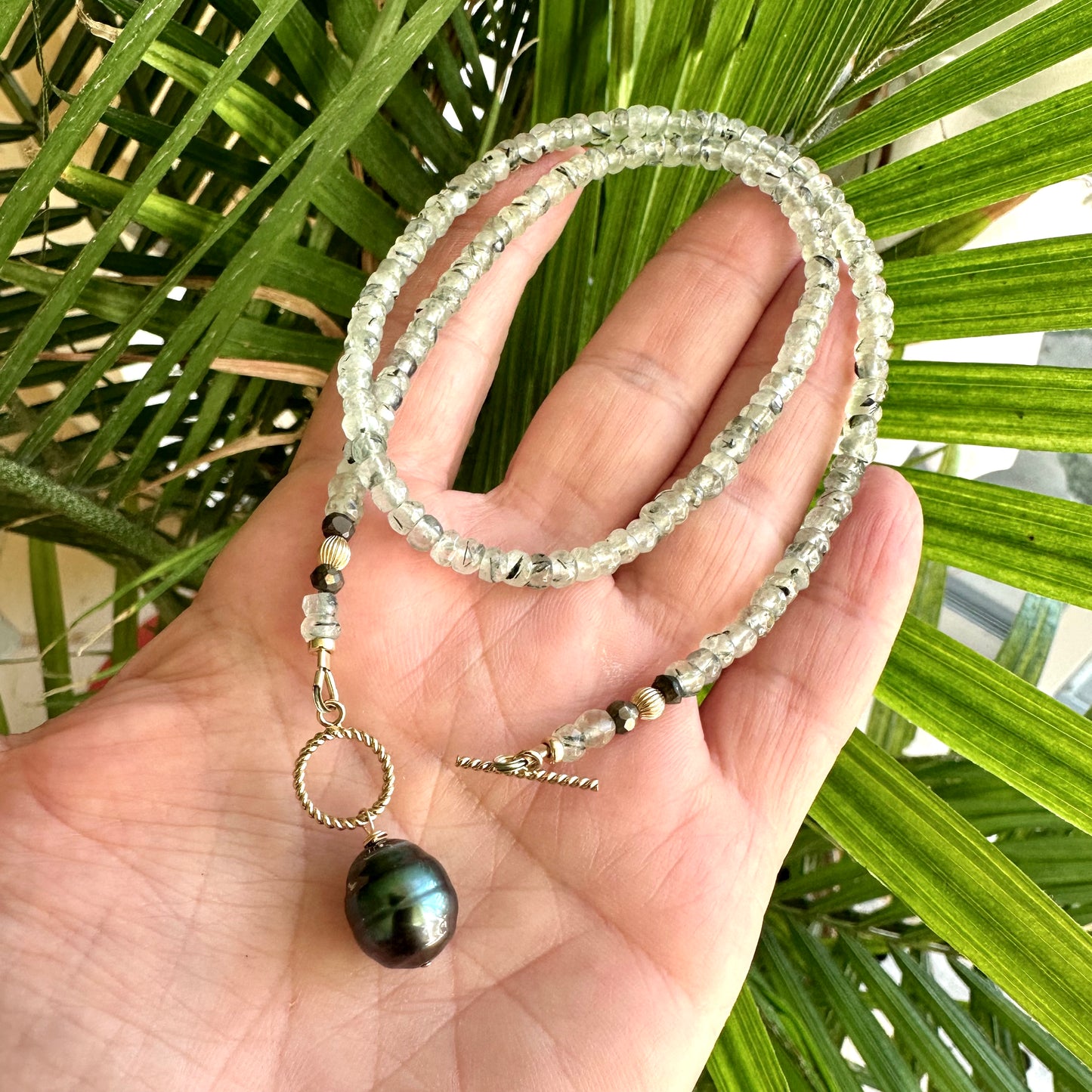 Prehnite tahitian pearl necklace close up showing Tahitian baroque pearl and prehnite beads
