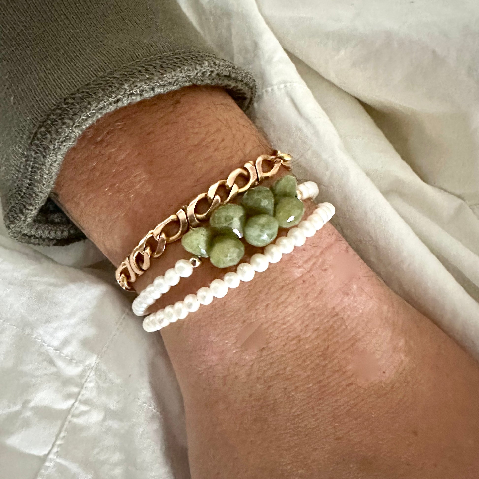 Double wrap pearl bracelet with olive green Vesuvianite, showcasing creamy pearls and earthy green tones.