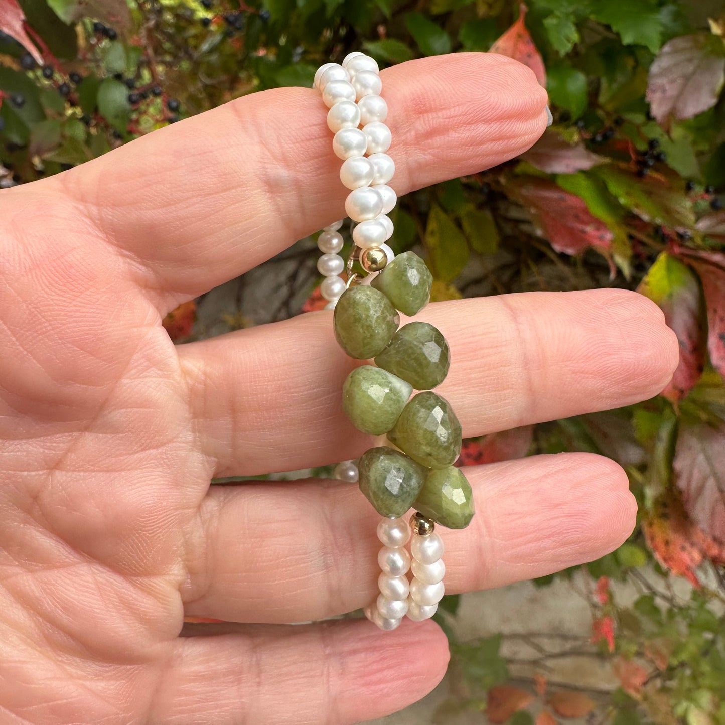 Double wrap pearl bracelet featuring freshwater pearls and olive green Vesuvianite gemstones.