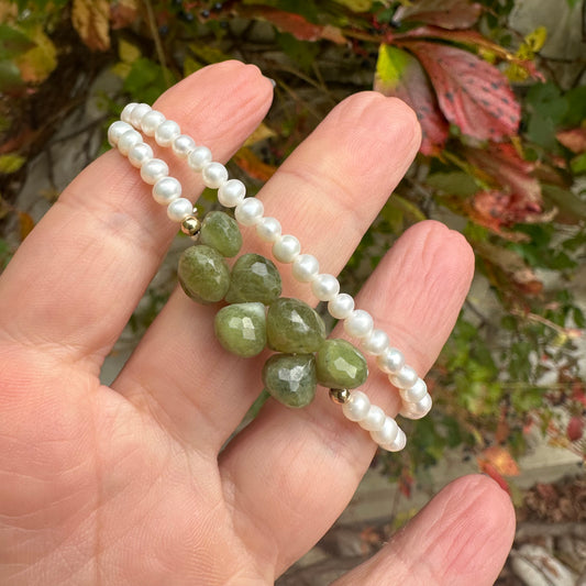 Double wrap pearl bracelet featuring creamy freshwater pearls and olive-green Vesuvianite gemstones.