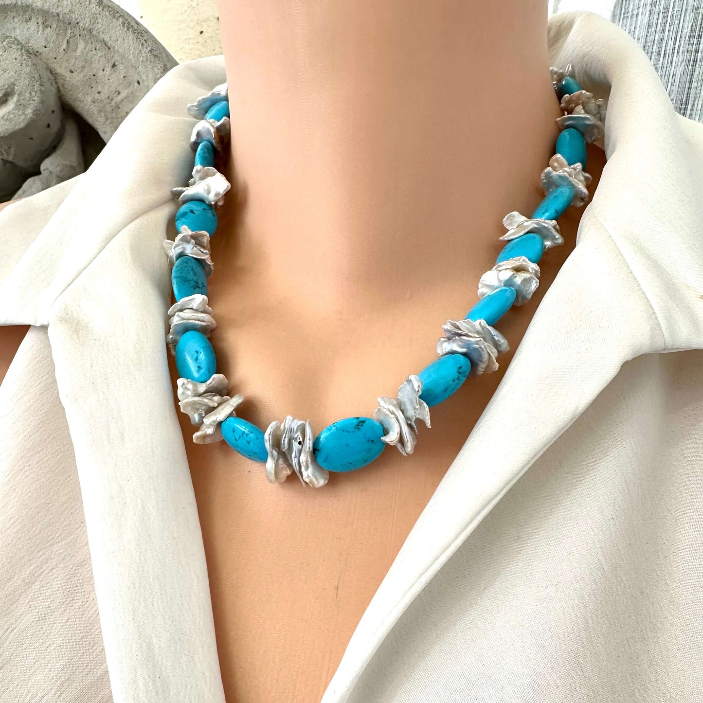 Chunky turquoise and silver grey keshi pearl necklace on mannequin, front view