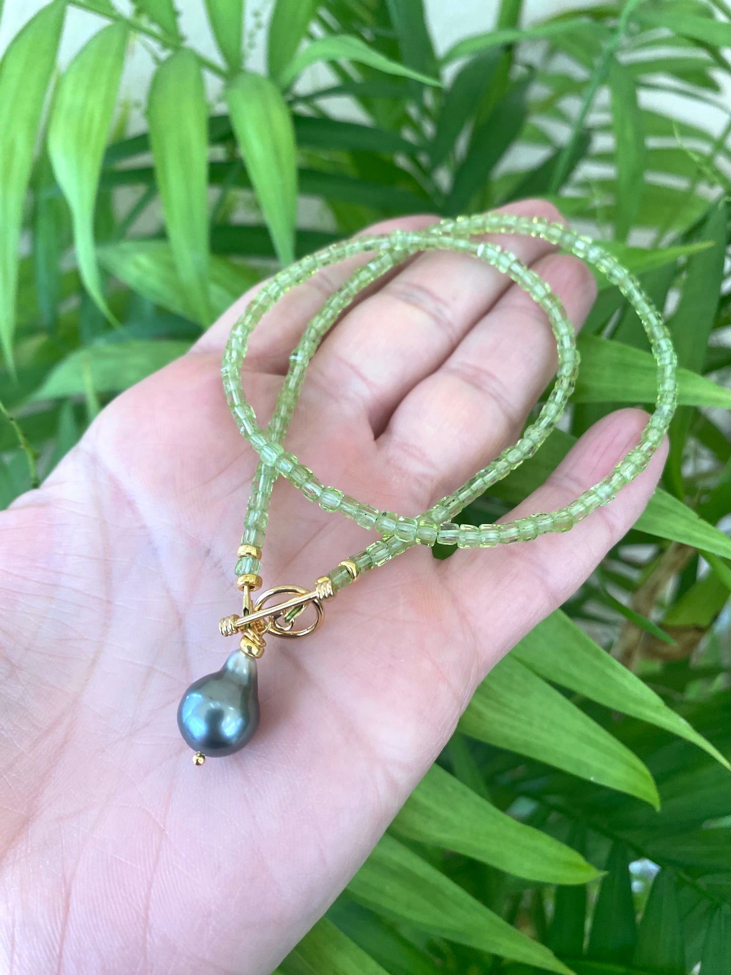 Peridot baroque pearl necklace featuring faceted Peridot beads and a Tahitian Baroque pearl pendant.
