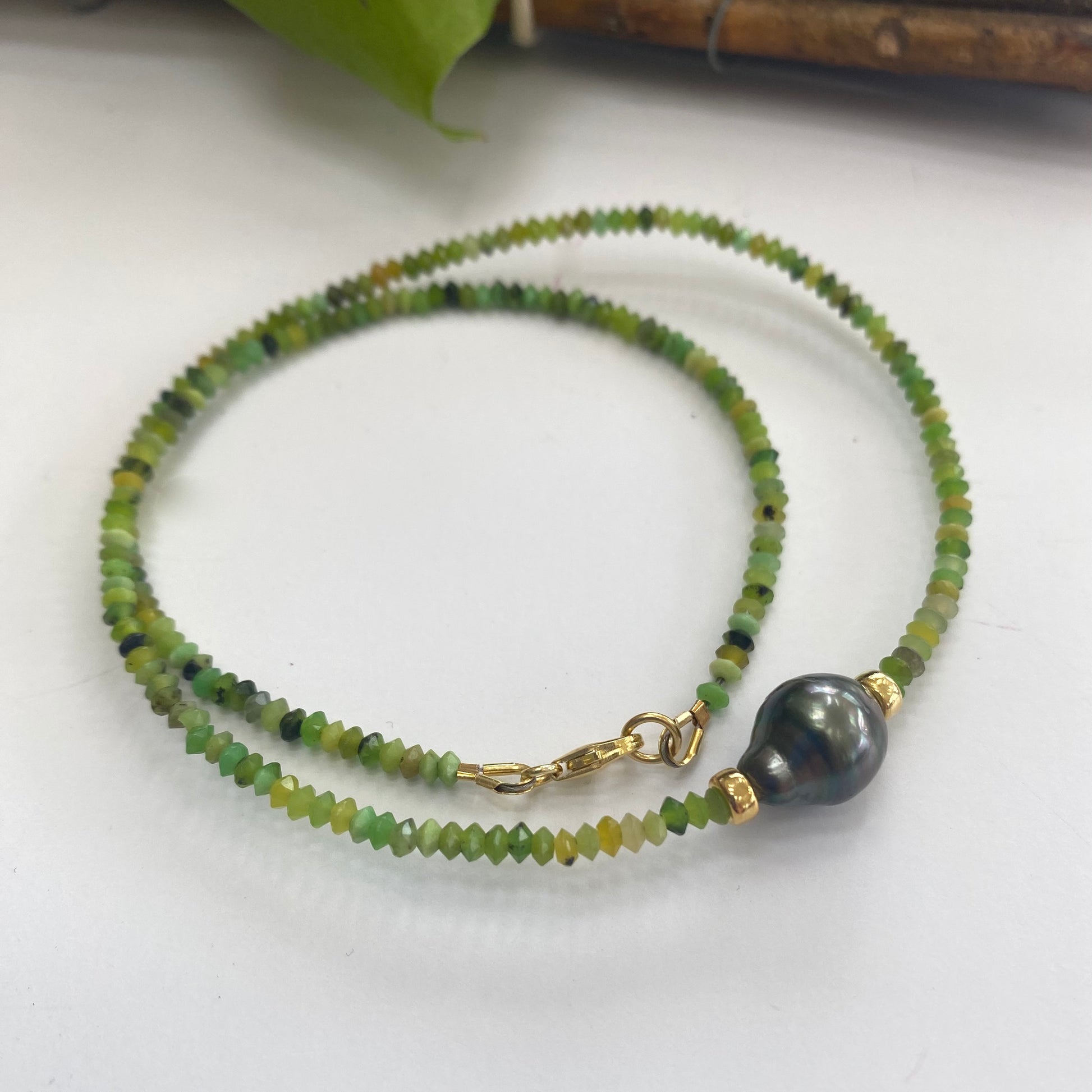 Green chrysoprase baroque pearl necklace featuring vibrant chrysoprase beads and a Tahitian baroque pearl.