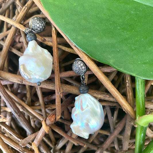 Baroque Pearl Drop Earrings featuring diamond pavé studs in oxidized silver against a natural background.