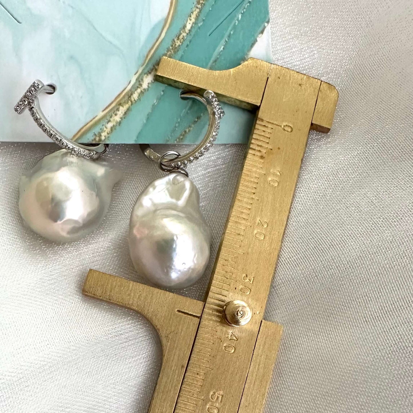 White Baroque Pearl Earrings – silver design measured for size against ruler