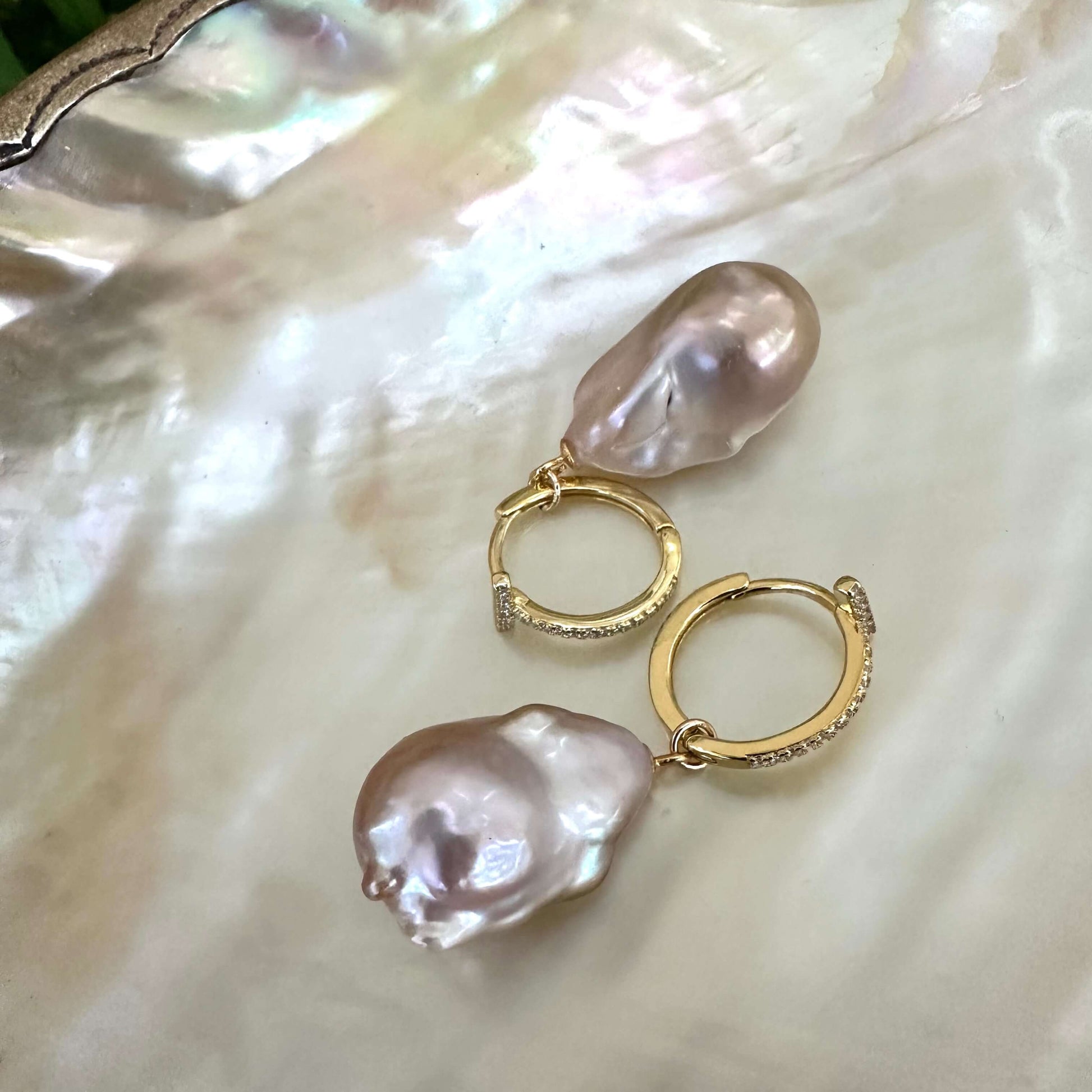 Pink baroque pearl hoop earrings displayed on pearl shell backdrop, CZ pavé gold vermeil hoops handmade in Canada.