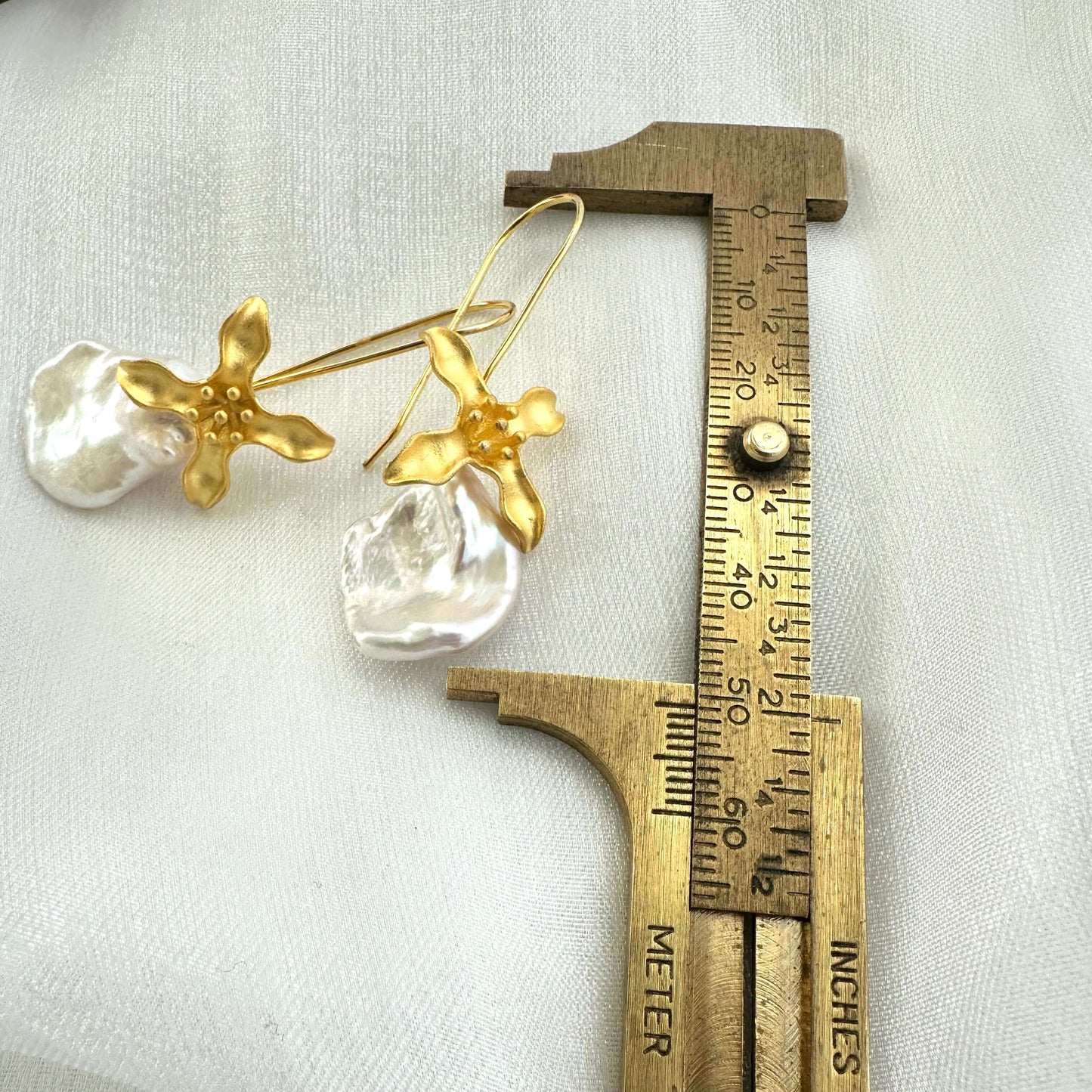 Keshi Pearl Earring showing full 50 mm drop length measured against ruler on white background for scale.