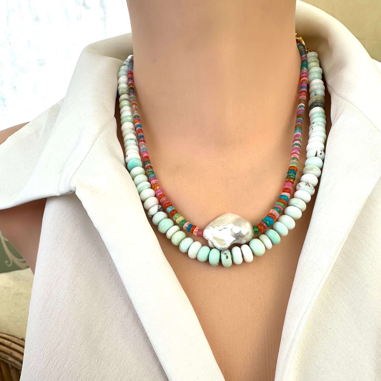 Front close-up of opal and baroque pearl necklace on mannequin display