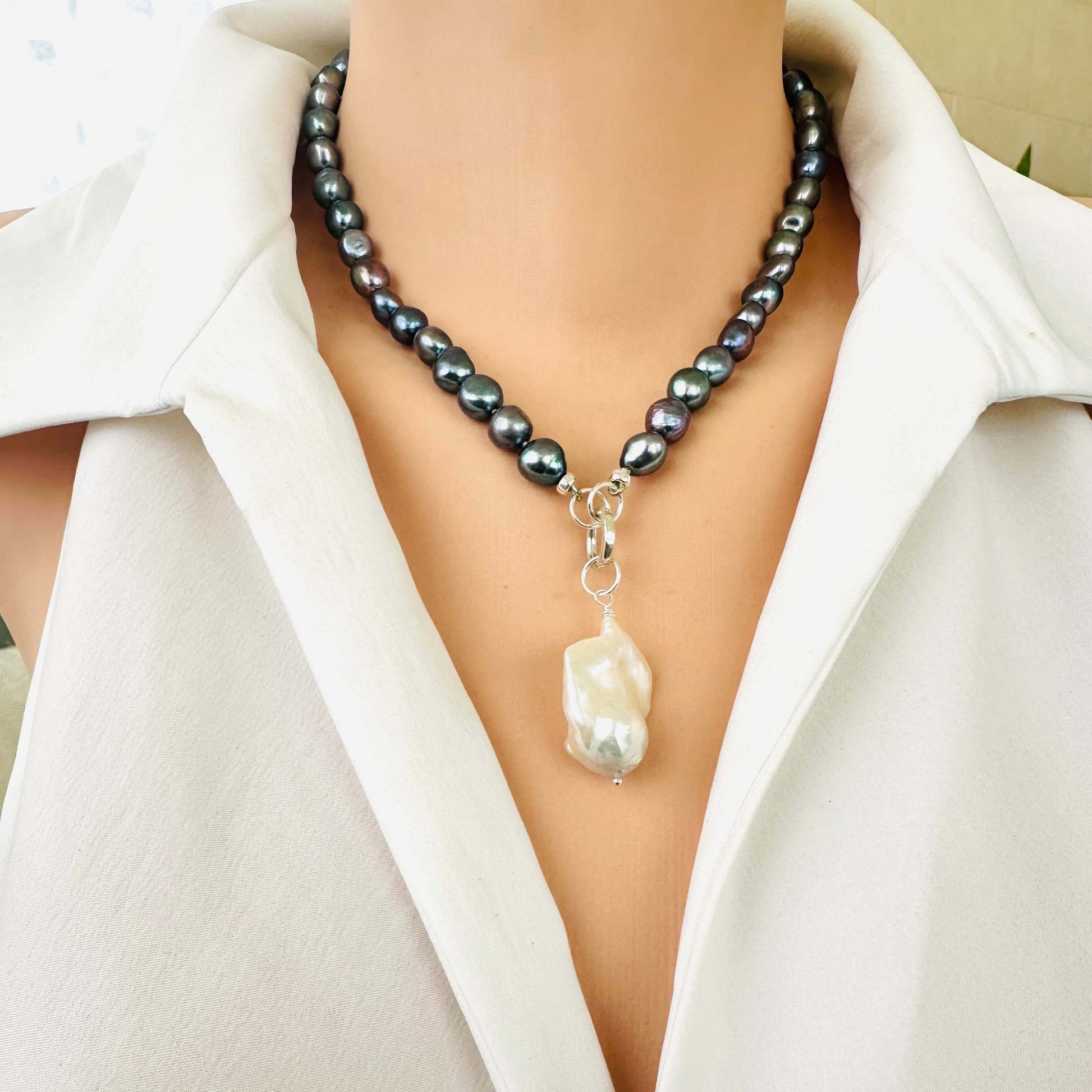 Front close-up of black pearl necklace with baroque pendant, handmade jewelry