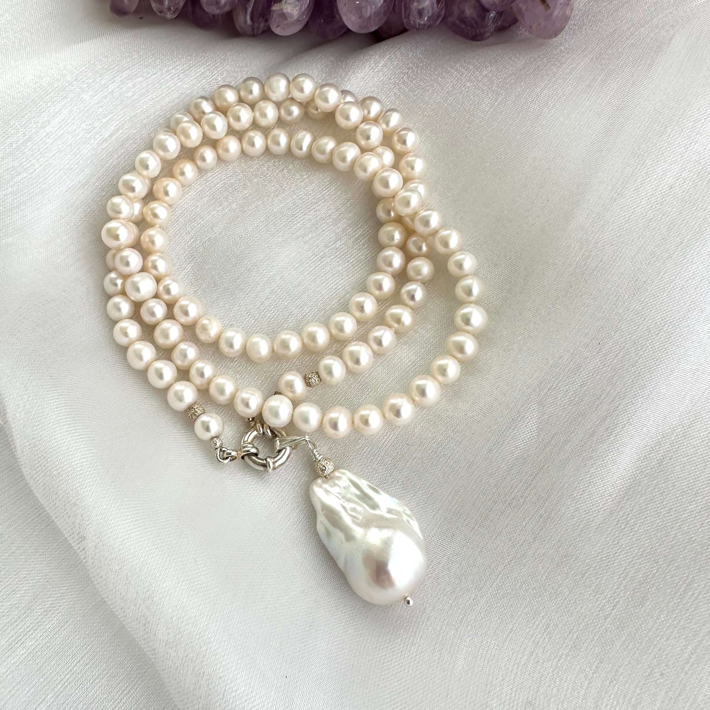 Detailed shot of handmade white pearl necklace pearls and silver clasp