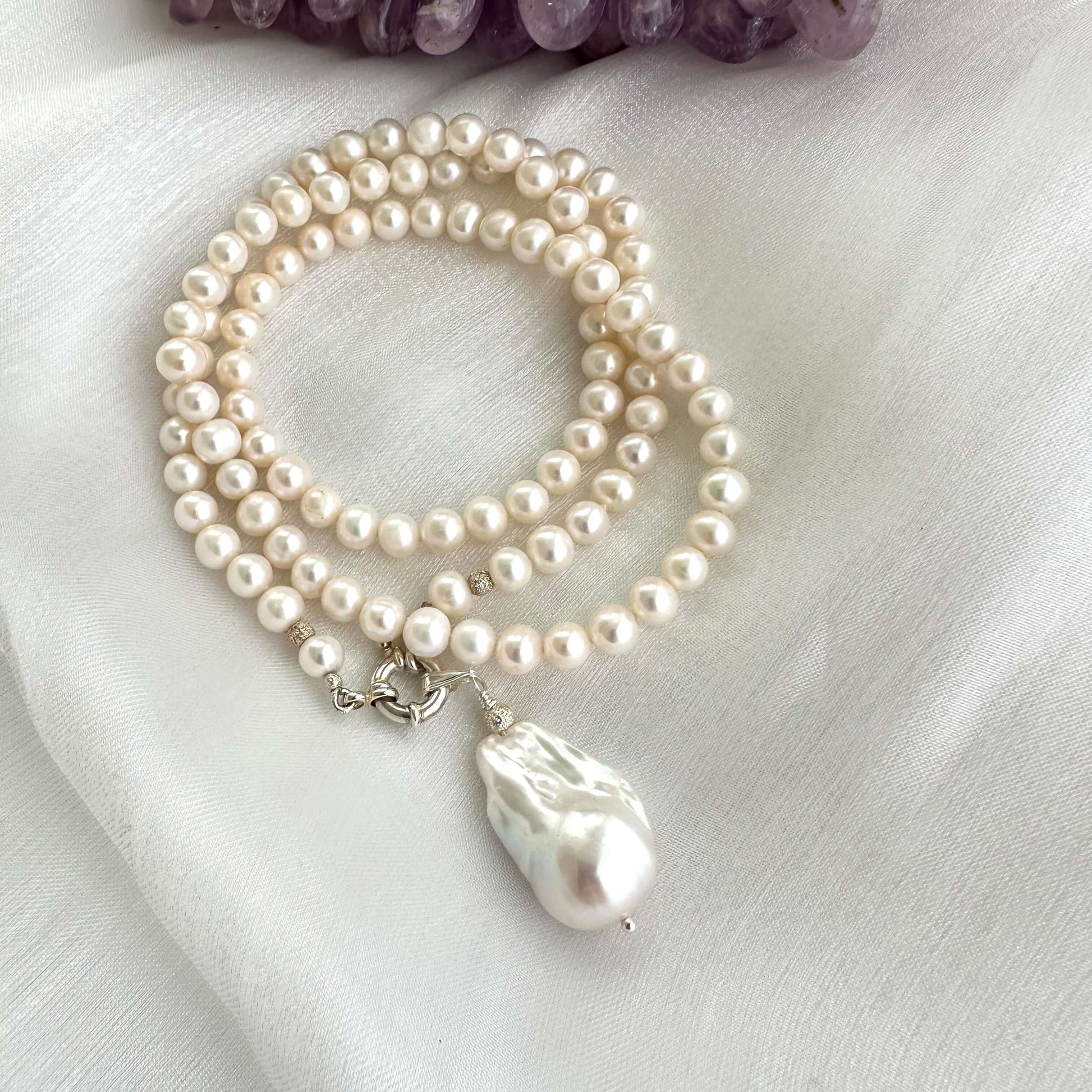 Detailed shot of handmade white pearl necklace pearls and silver clasp