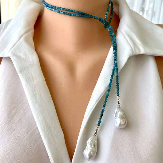 Blue Apatite Lariat Necklace with Baroque Pearls worn on a white blouse, showcasing its elegance and versatility.