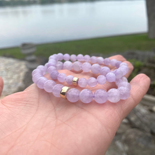 Lavender Amethyst Bracelet held in hand against lake view – outdoor close-up