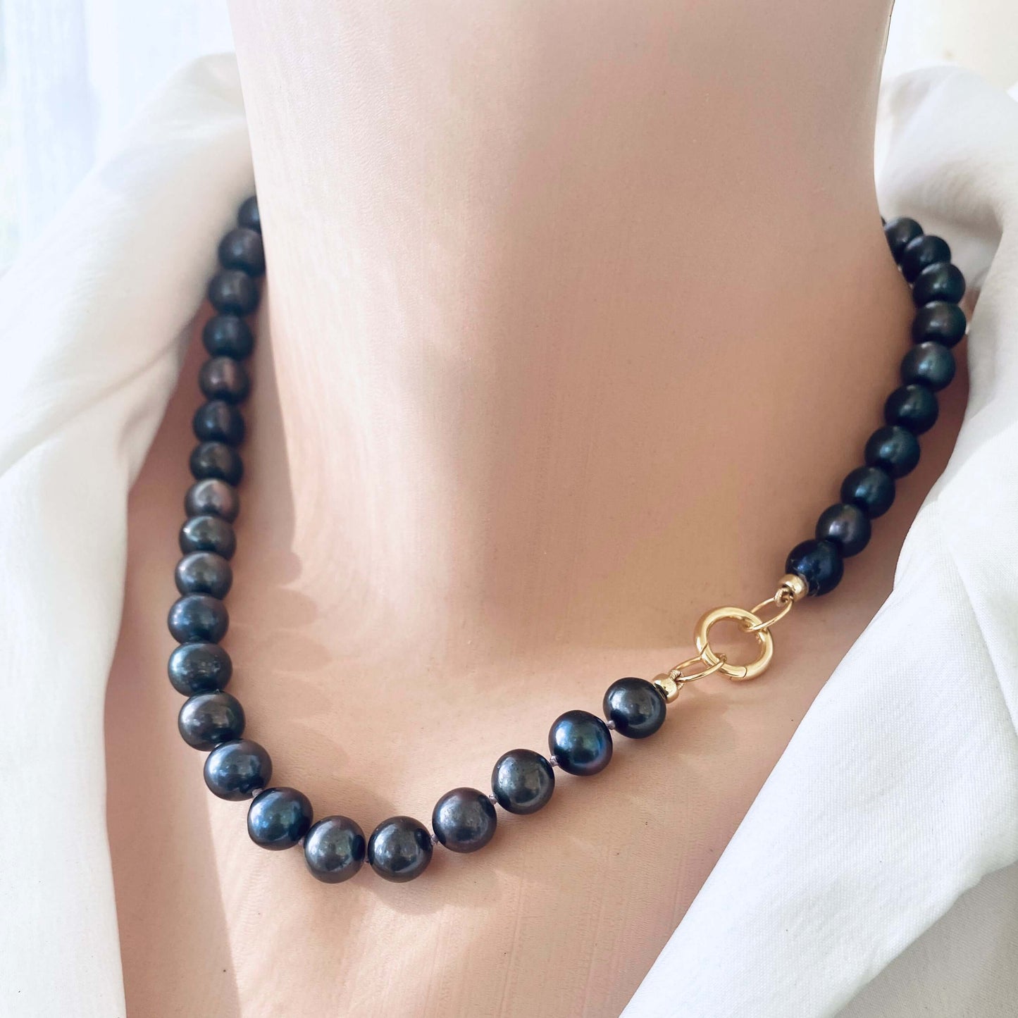 Black pearl necklace without pendant displayed on mannequin