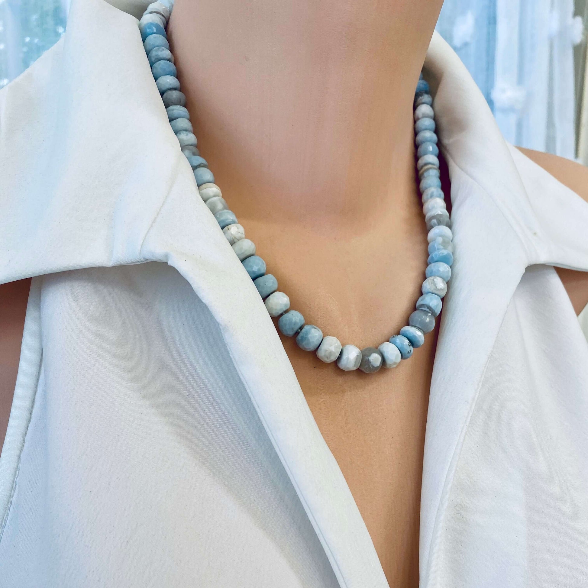 Blue grey opal necklace displayed on mannequin, side angle under natural light