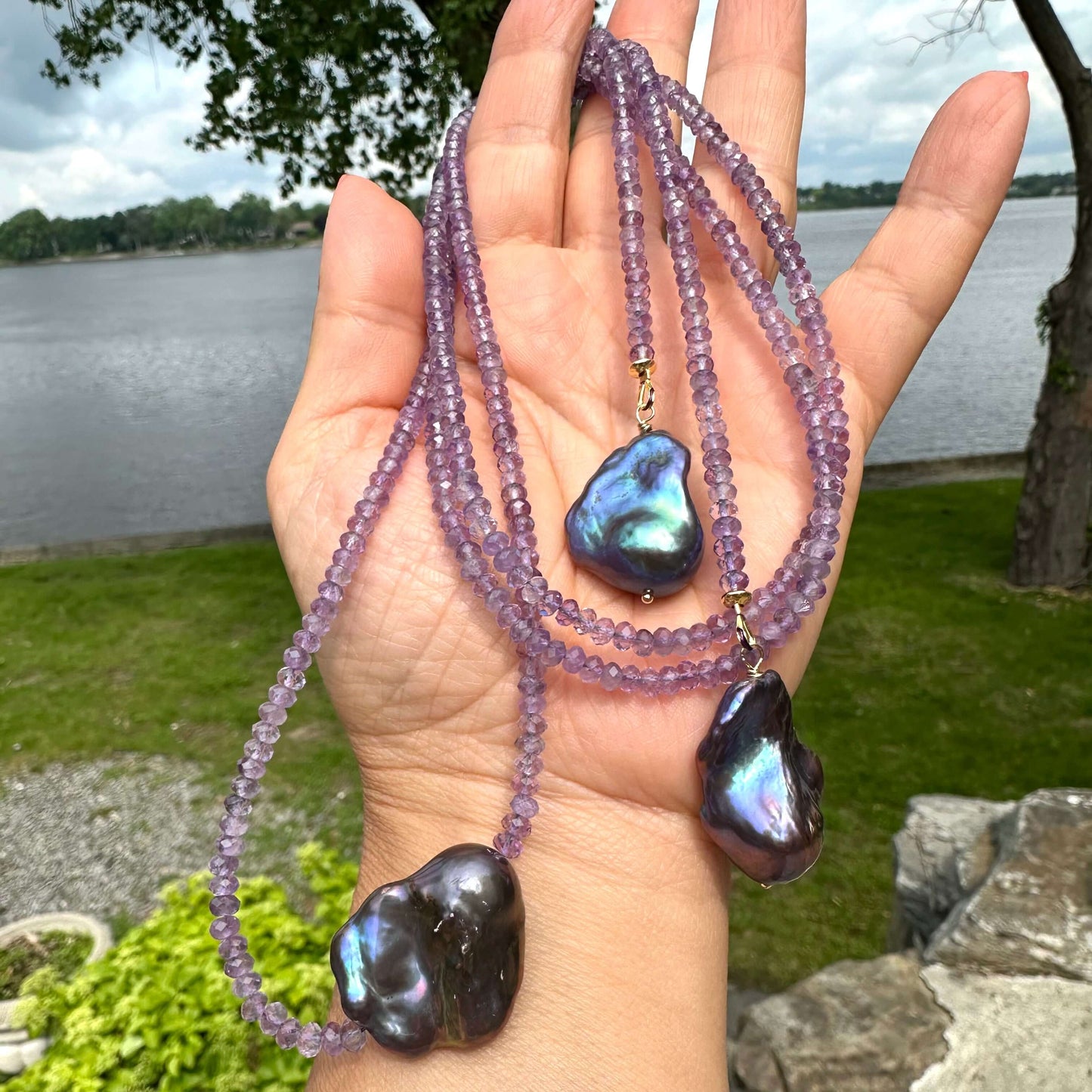 Handcrafted Amethyst and Black Baroque Pearl Lariat Necklace photographed in nature — elegant gemstone and pearl design by Loulia Pearl Jewelry