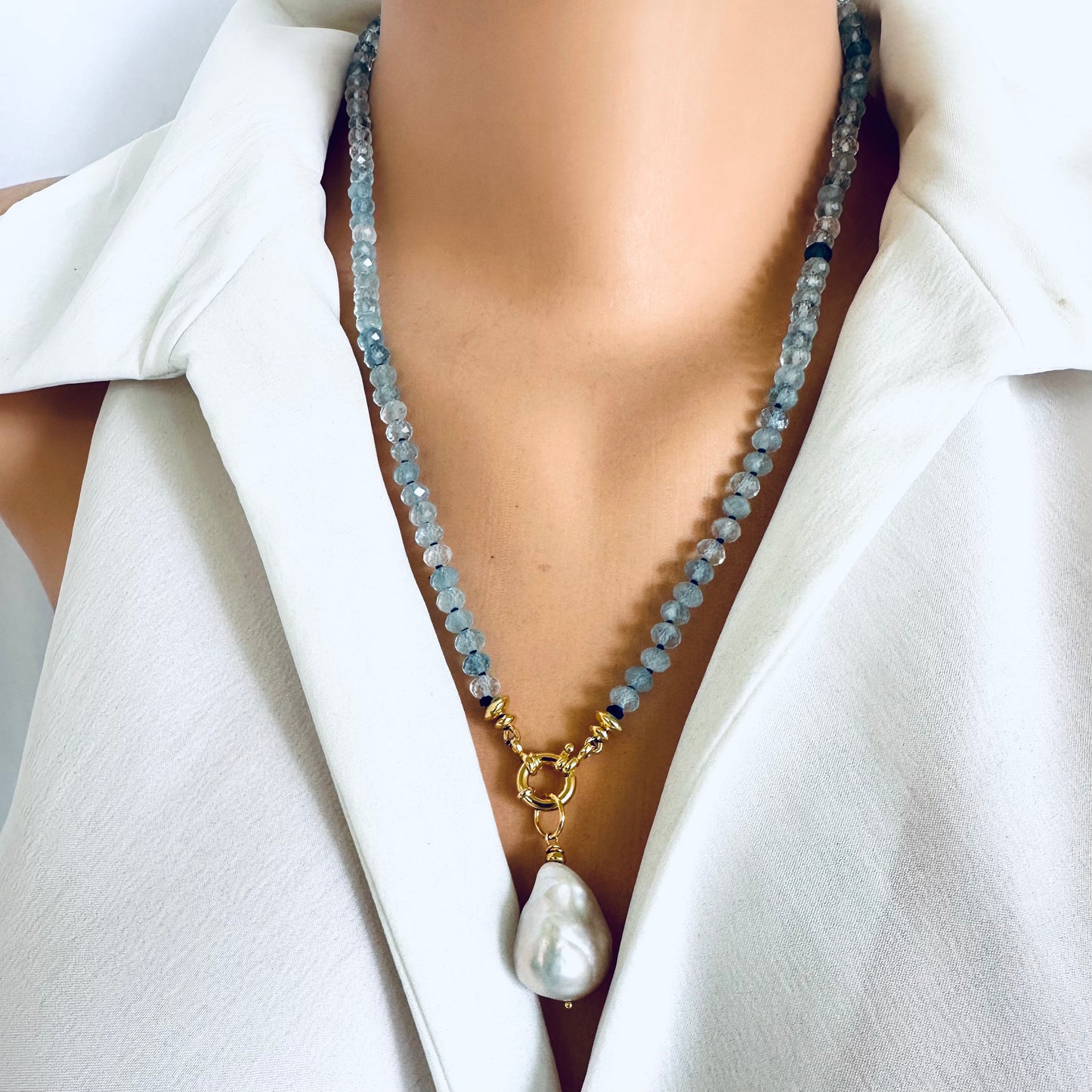 Aquamarine baroque pearl necklace featuring blue gemstones and a luminous Baroque pearl pendant.