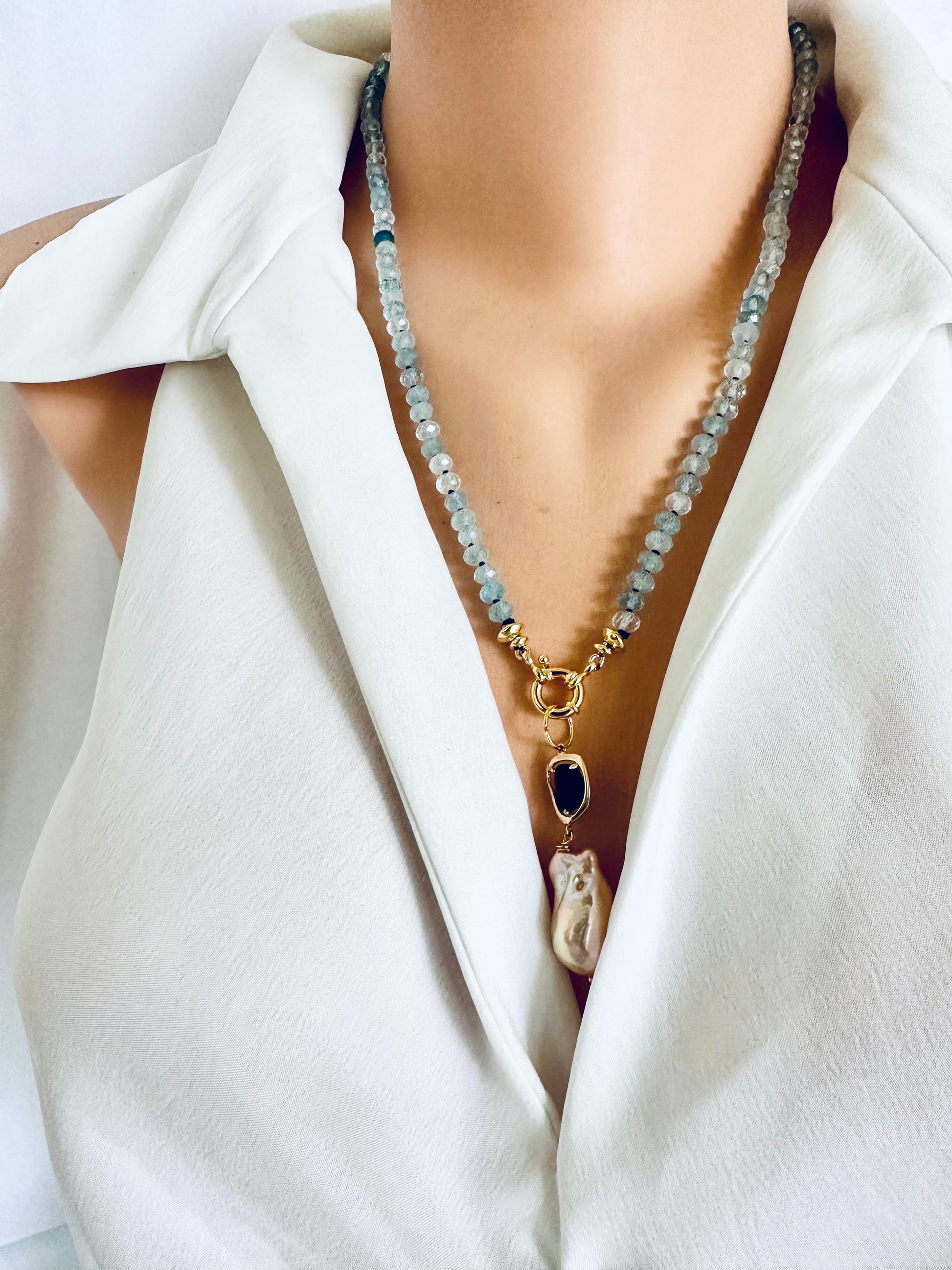 Aquamarine baroque pearl necklace featuring blue aquamarine beads and a luminous baroque pearl pendant.