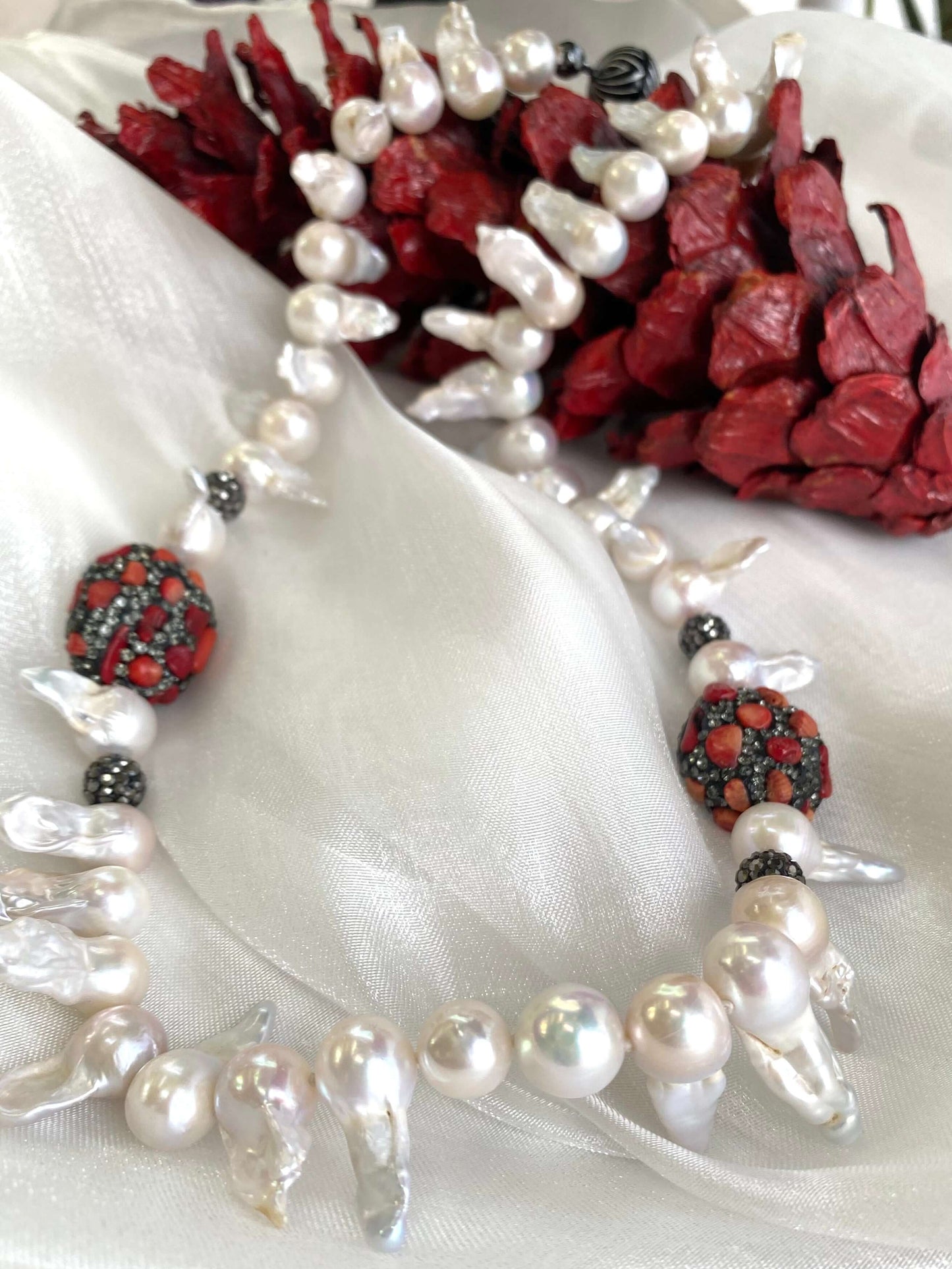 Baroque pearl jellyfish necklace red coral on white cloth with red pine cone handmade in Canada