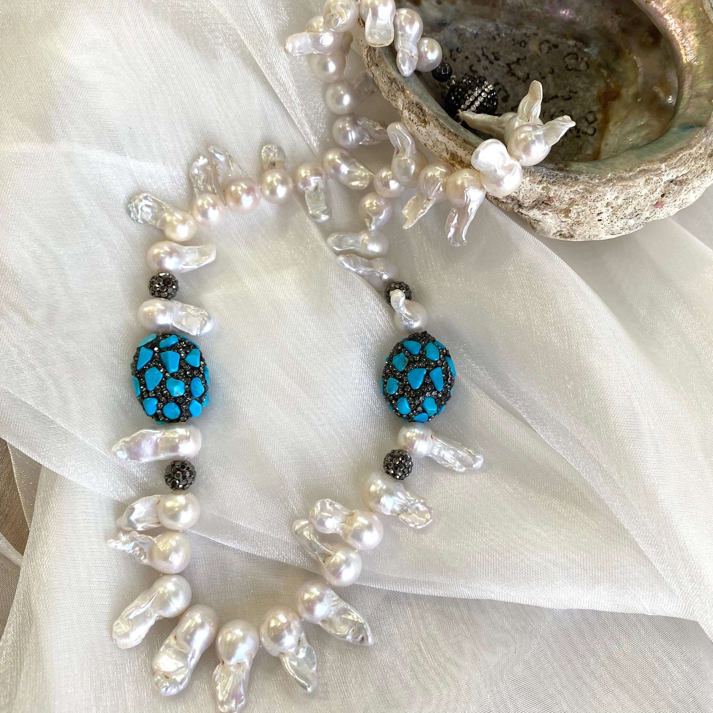Ocean inspired baroque pearl jellyfish necklace on white cloth handmade in Canada