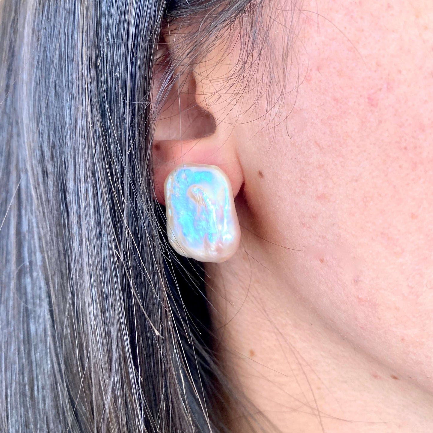 Golden pink rectangle baroque pearl stud earrings worn by woman, rectangular freshwater pearls handmade in Canada.