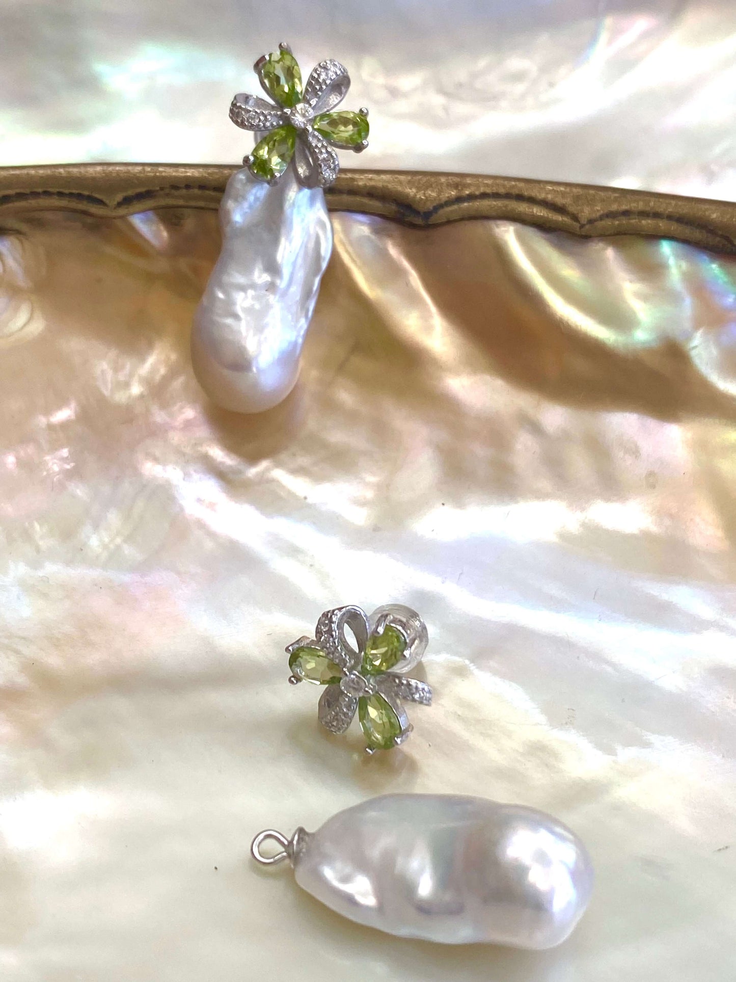 Peridot stud earrings with removable baroque pearl drops shown beside stud