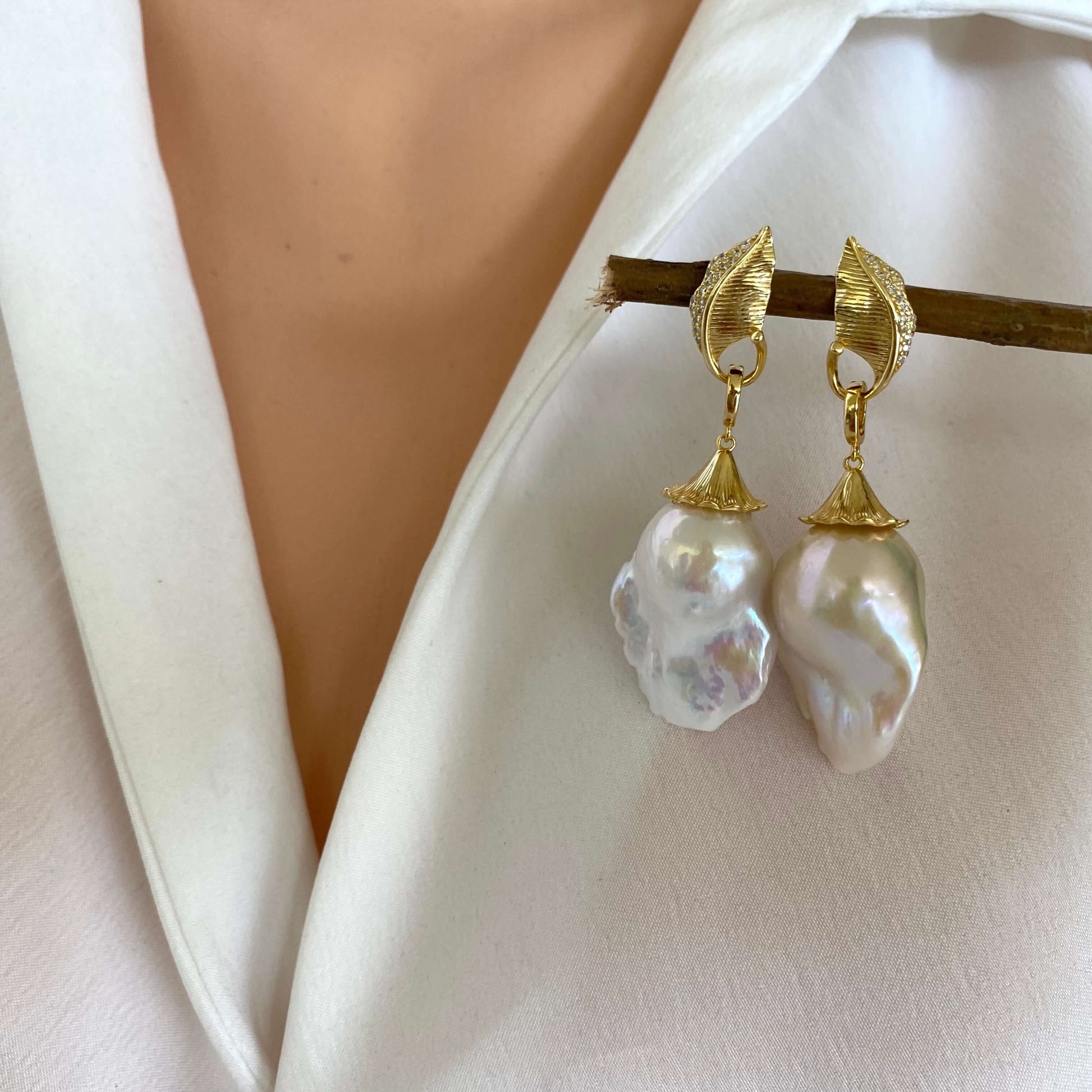 Close-up of leaf design pearl earrings with gold vermeil and baroque pearl drops, perfect botanical jewelry.