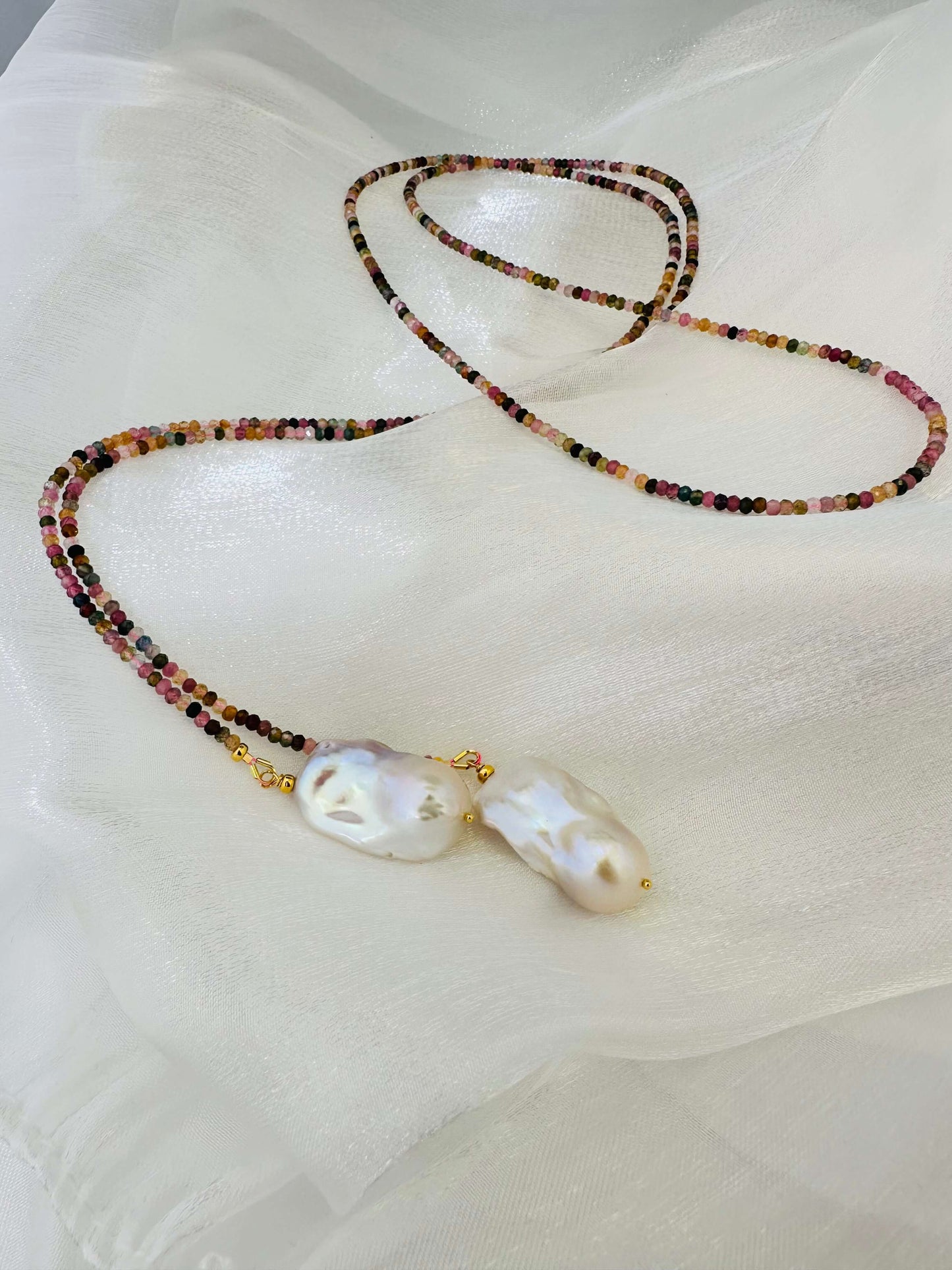 Detailed view of Multi Tourmaline Baroque Pearl Lariat Necklace on white surface — colorful tourmaline and white pearls by Loulia Pearl Jewelry